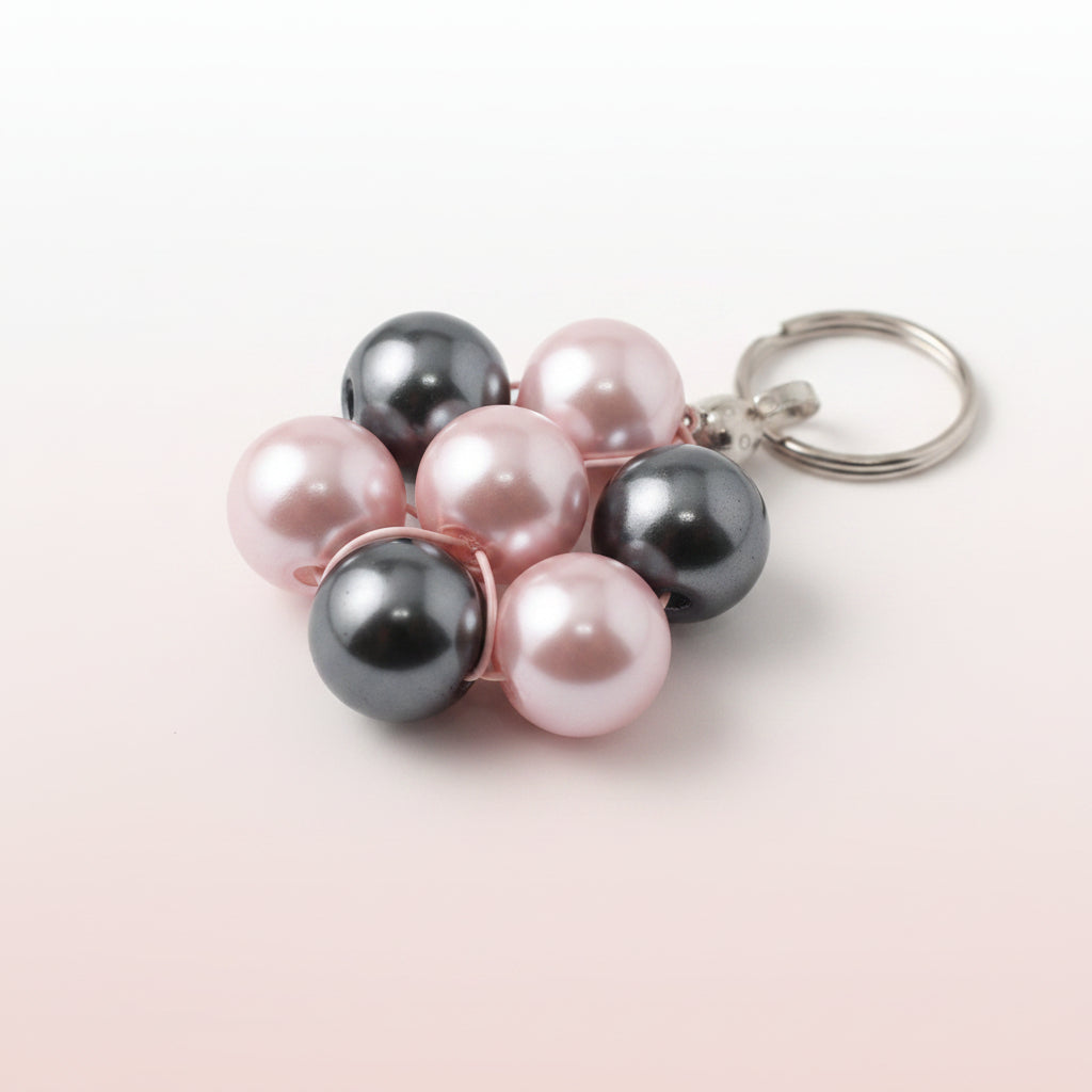 Cluster of pink and black pearls on a white background