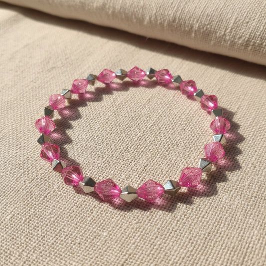 Bracelet with pink and silver beads on a gray background