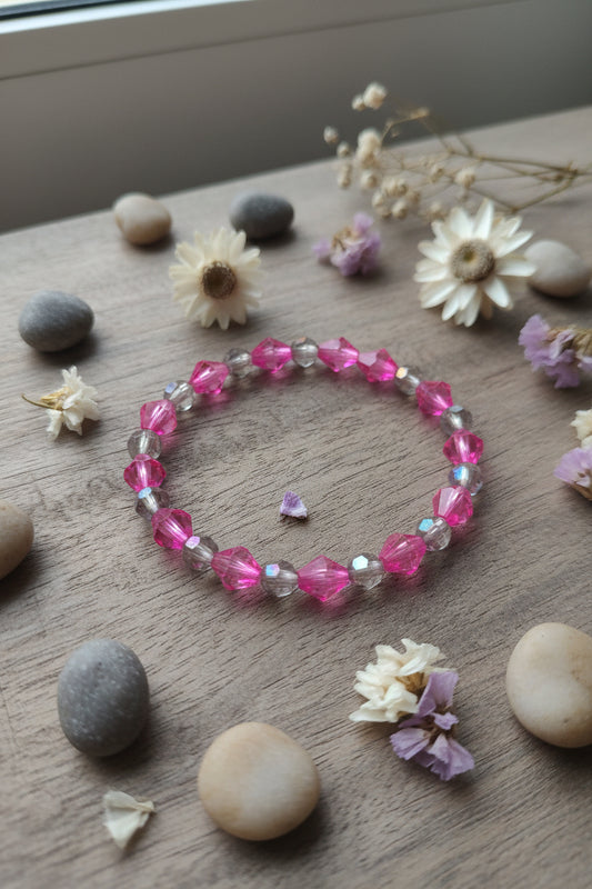 Bracelet with pink and clear beads on a light gray background