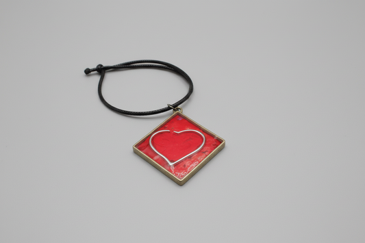 Diamond shaped and within a Silver and Red Heart takes center stage.