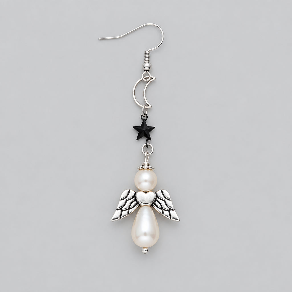 A single dangling earring with a silver-toned fishhook wire, a small black star charm, a silver heart-shaped connector, a cream pearl bead, and a silver angel pendant with wings and a teardrop pearl, shown on a solid pink background.