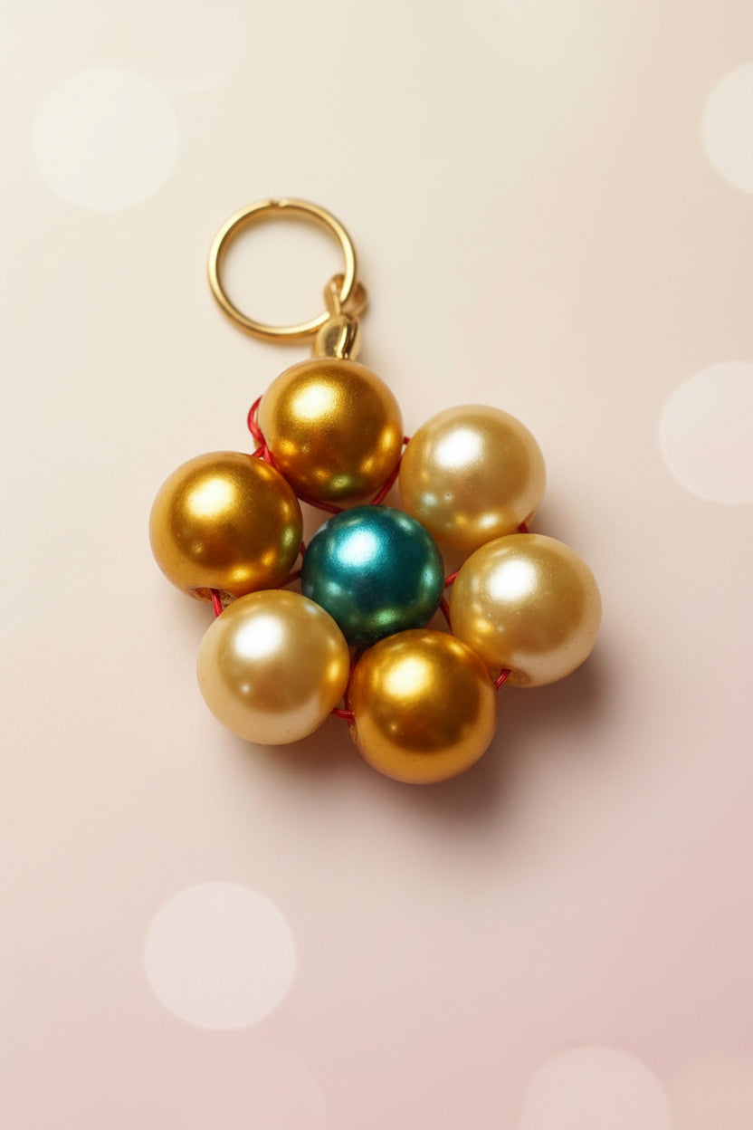 Yellow pearl beads with a single teal-coloured pearl beads set in the centre