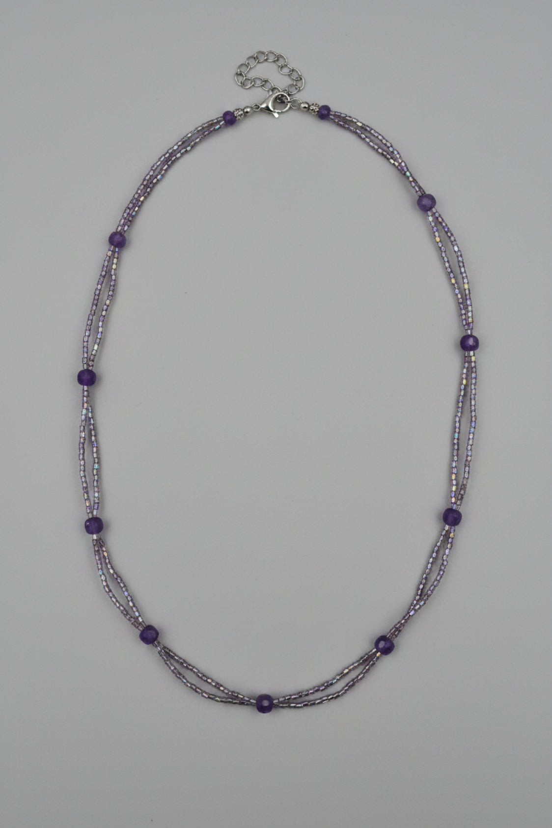 Beaded necklace on a light gray fabric background