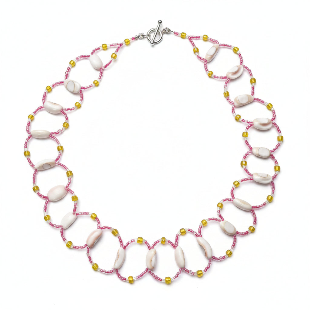Necklace with pink and gold beads on a white background