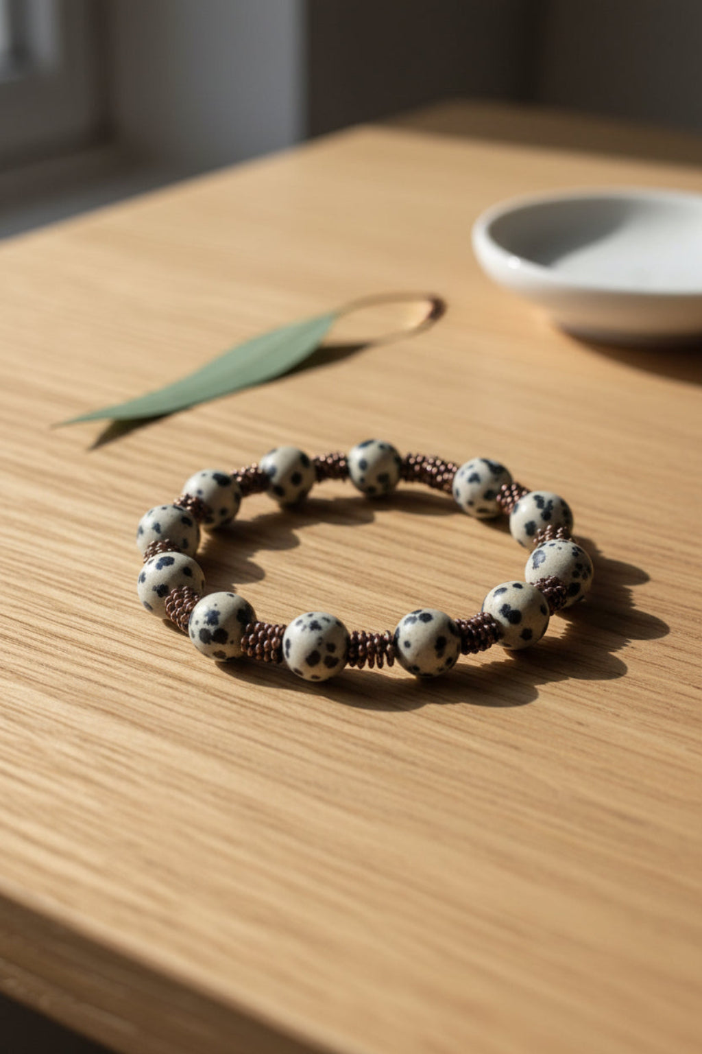 Bracelet with black and white beads on a wooden surface
