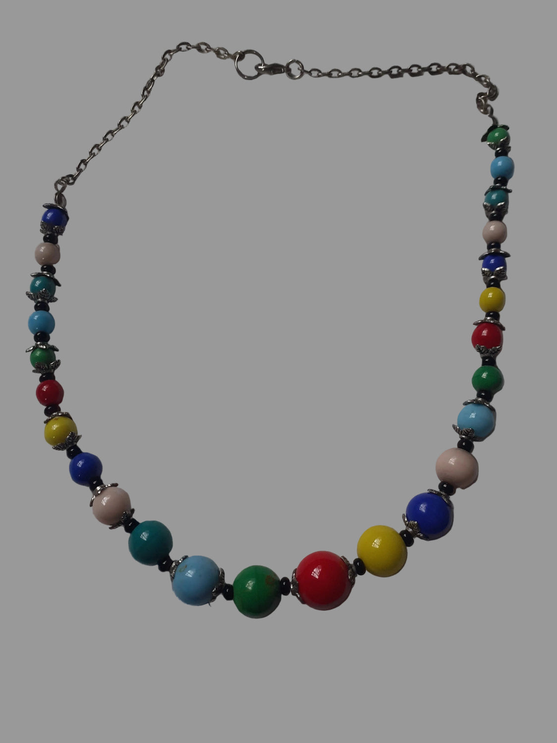 Colorful beaded necklace on a light gray background