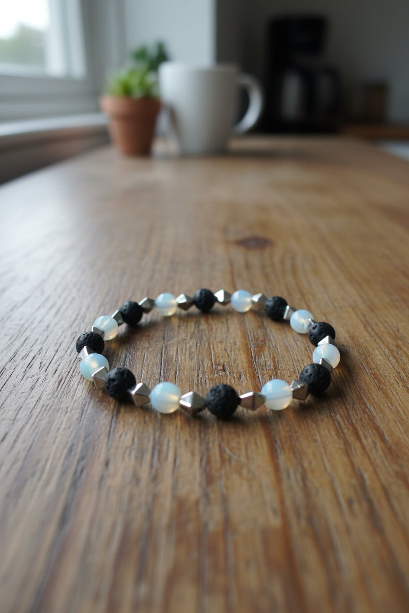 Bracelet with black, white, and silver beads on a gray background