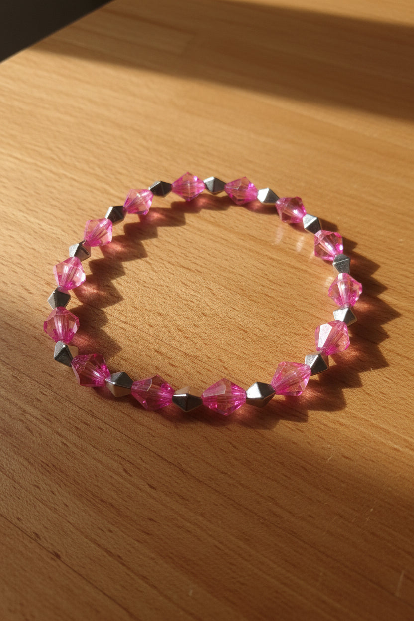 Bracelet with pink and silver beads on a gray background
