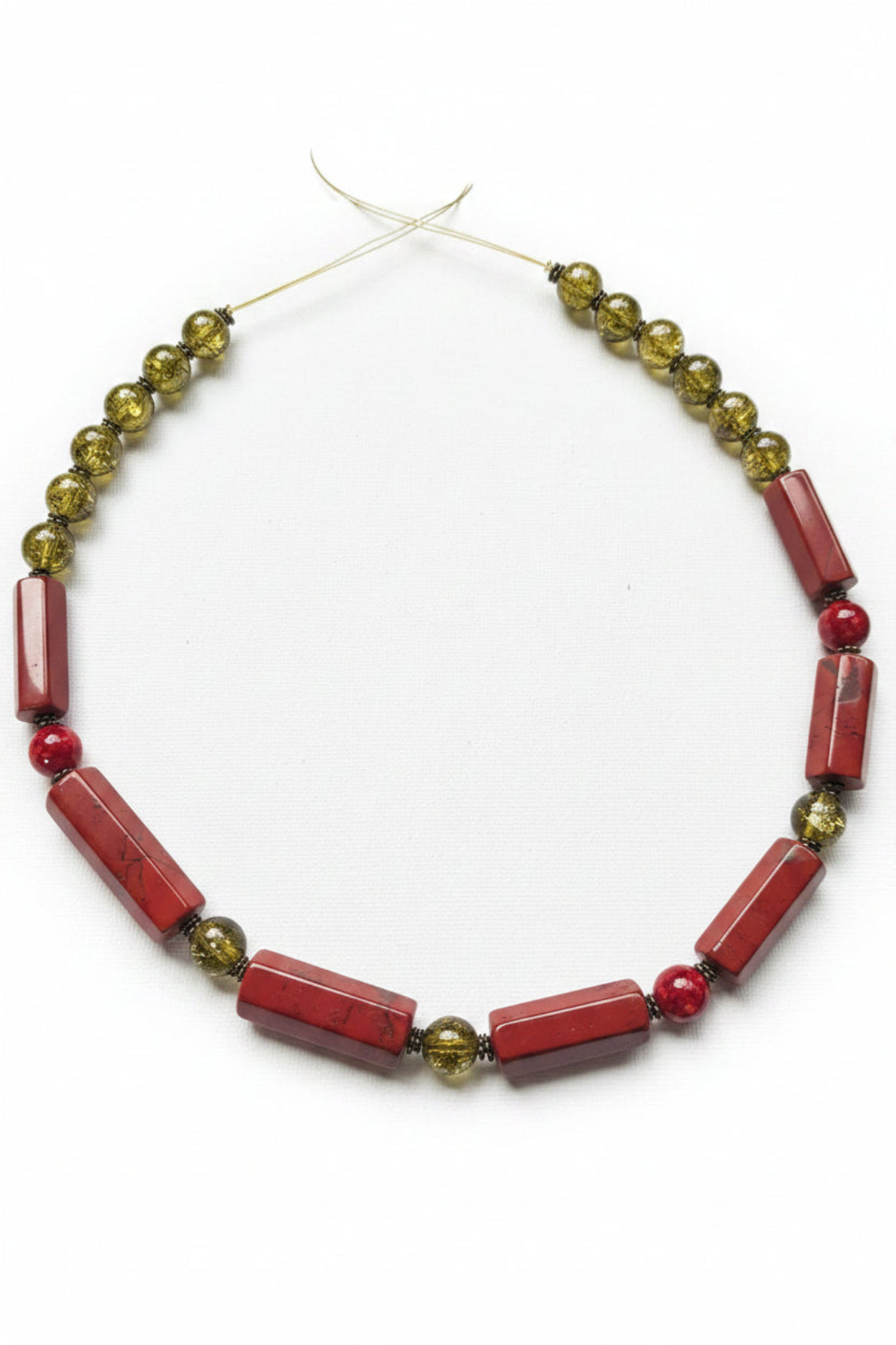 Necklace with red and green beads on a white background