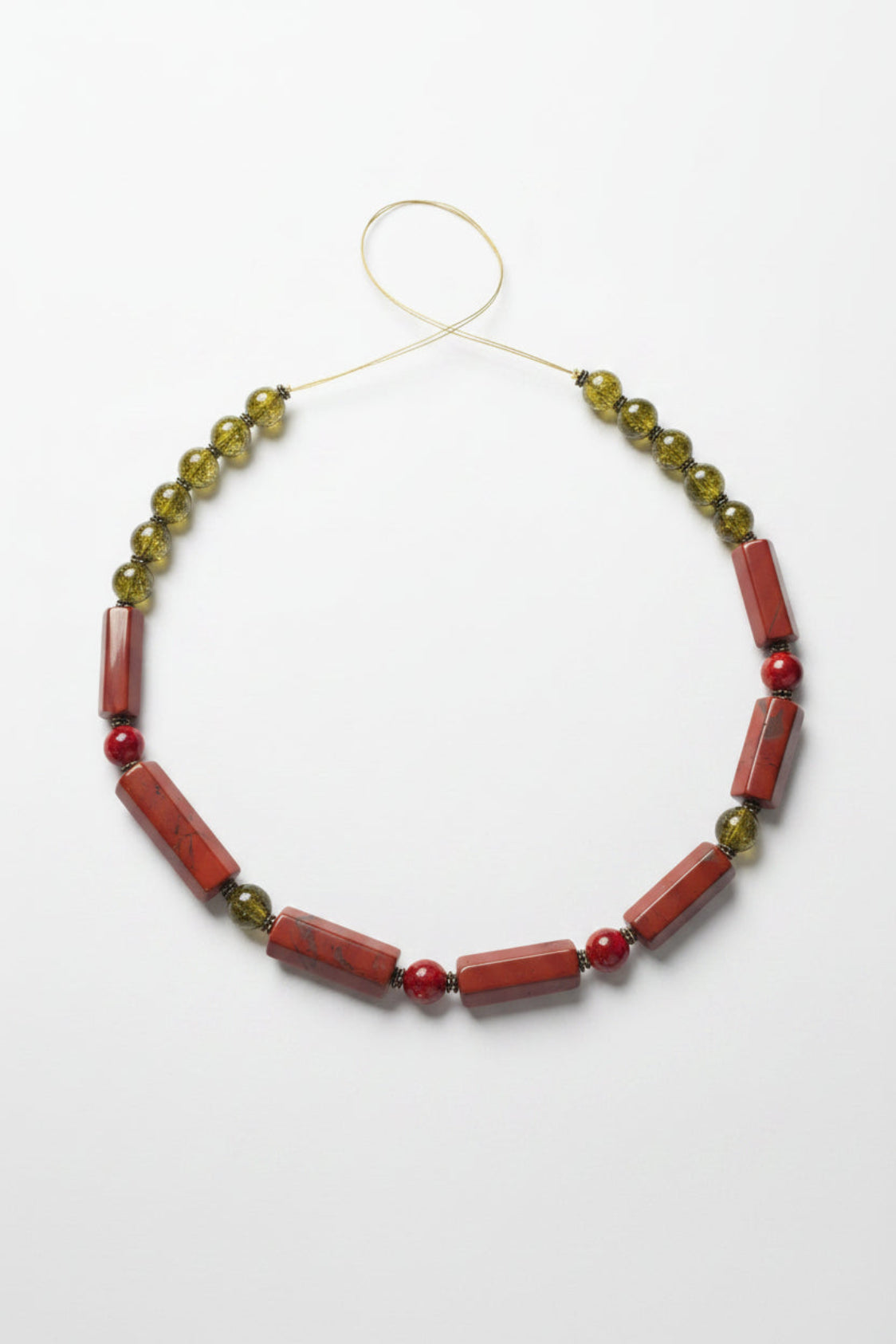 Necklace with red and green beads on a white background