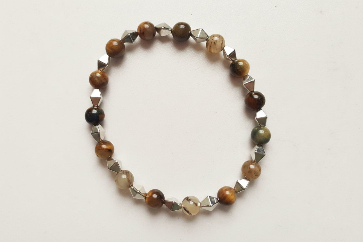 Bracelet with brown and silver beads on a light gray background
