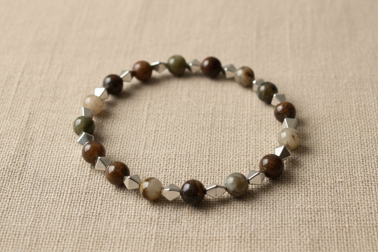 Bracelet with brown and silver beads on a light gray background