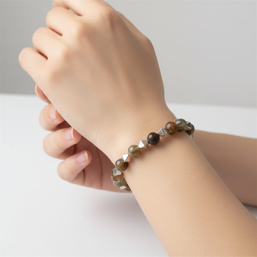 Bracelet with brown and silver beads on a light gray background